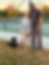 dog owners standing with dog in park