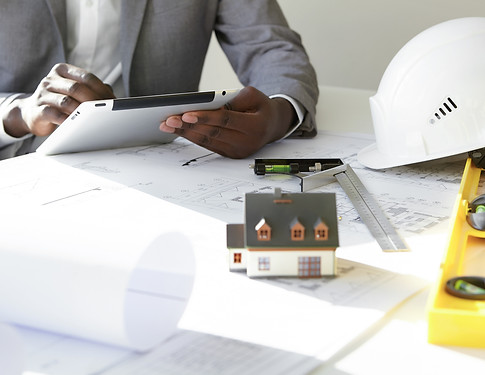 cropped-shot-dark-skinned-contractor-holding-touch-pad-entering-data-while-working-new-hou