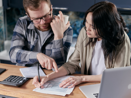 A roofing sales representative reviews inspection photos and proposal options with a homeowner during a consultation.