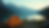 Wide angle view of a serene camp setup by a lake with mountains in the background