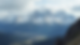 Wide angle view of sharp silver-gray peaks of the Pioneer Mountains rising above open valleys