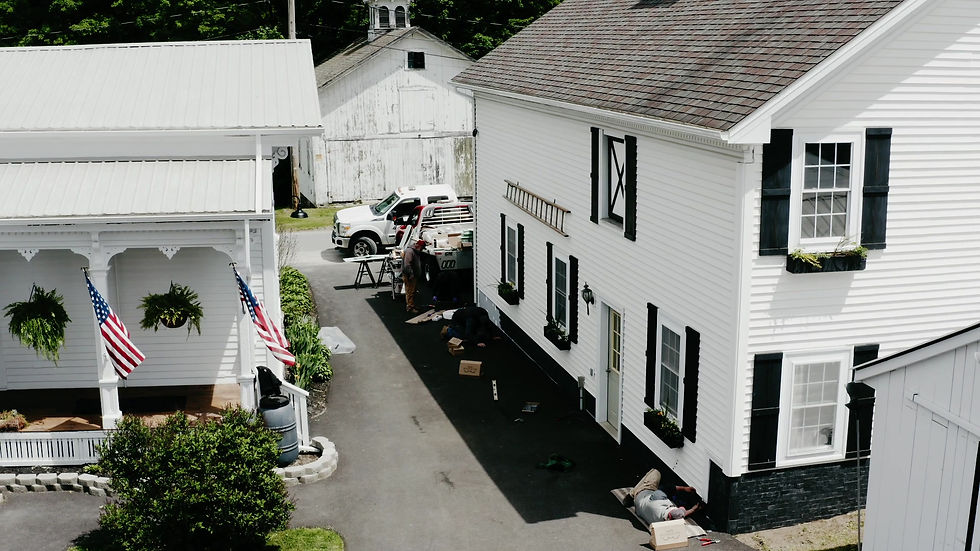 Thumbnail: Aerial view of modern farmhouse with black slate tile foundation