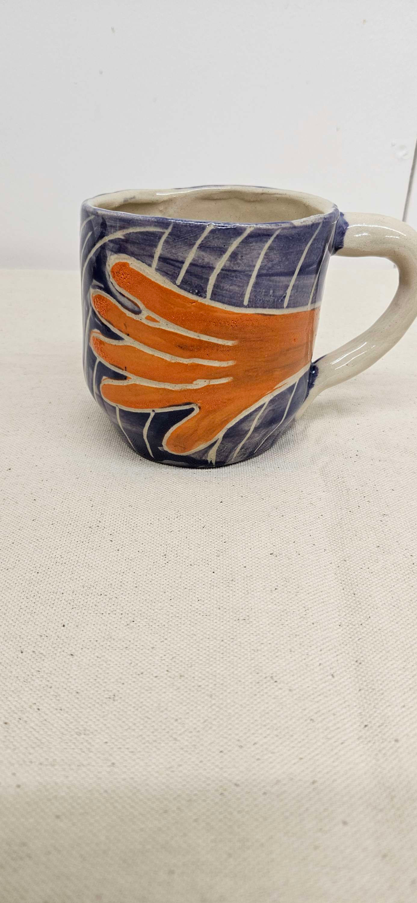 Hand motif carved textured coffee mug