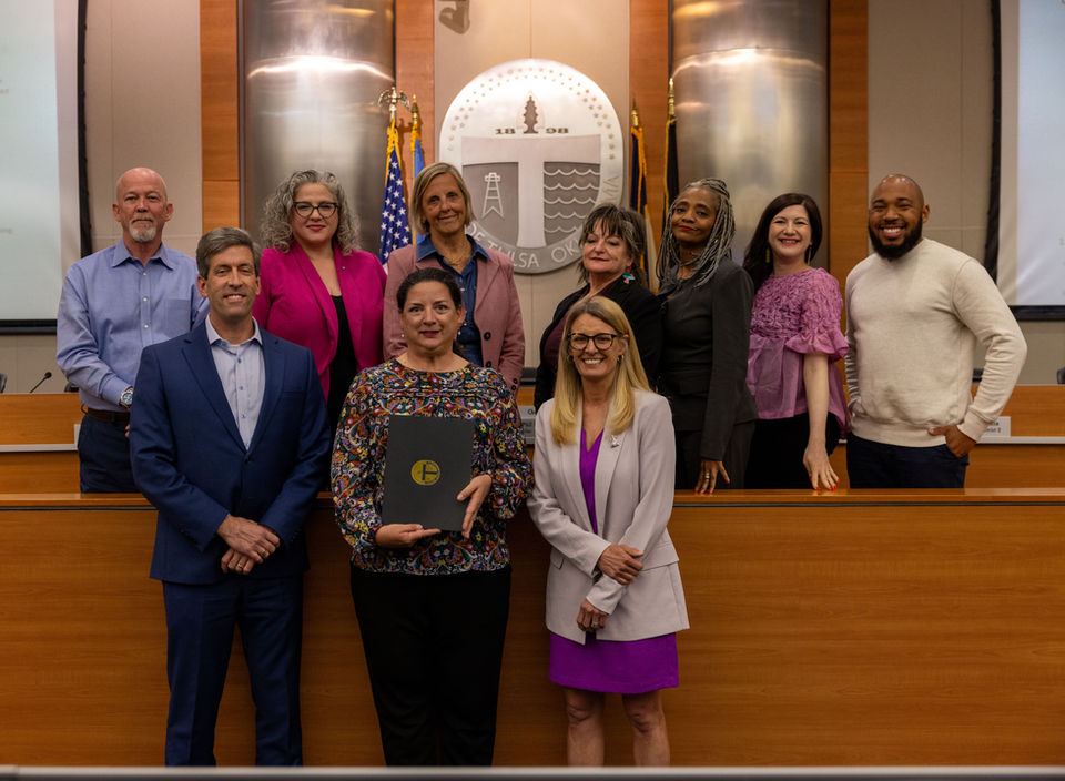 Councilor Gilbert and other Councilors post with a guest receiving a proclamation
