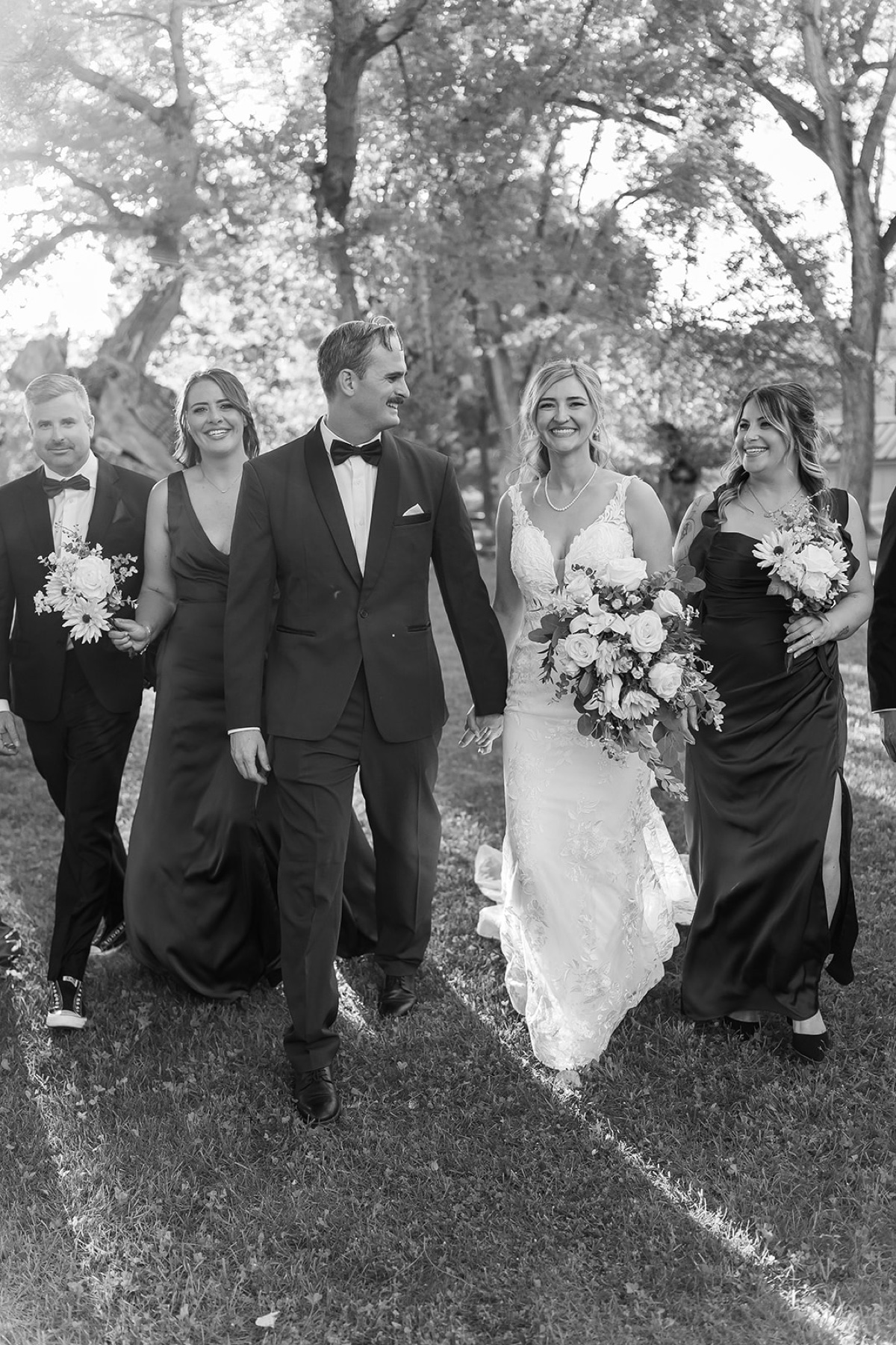 A newly married couple walking with their closest friends during an intimate Arizona wedding