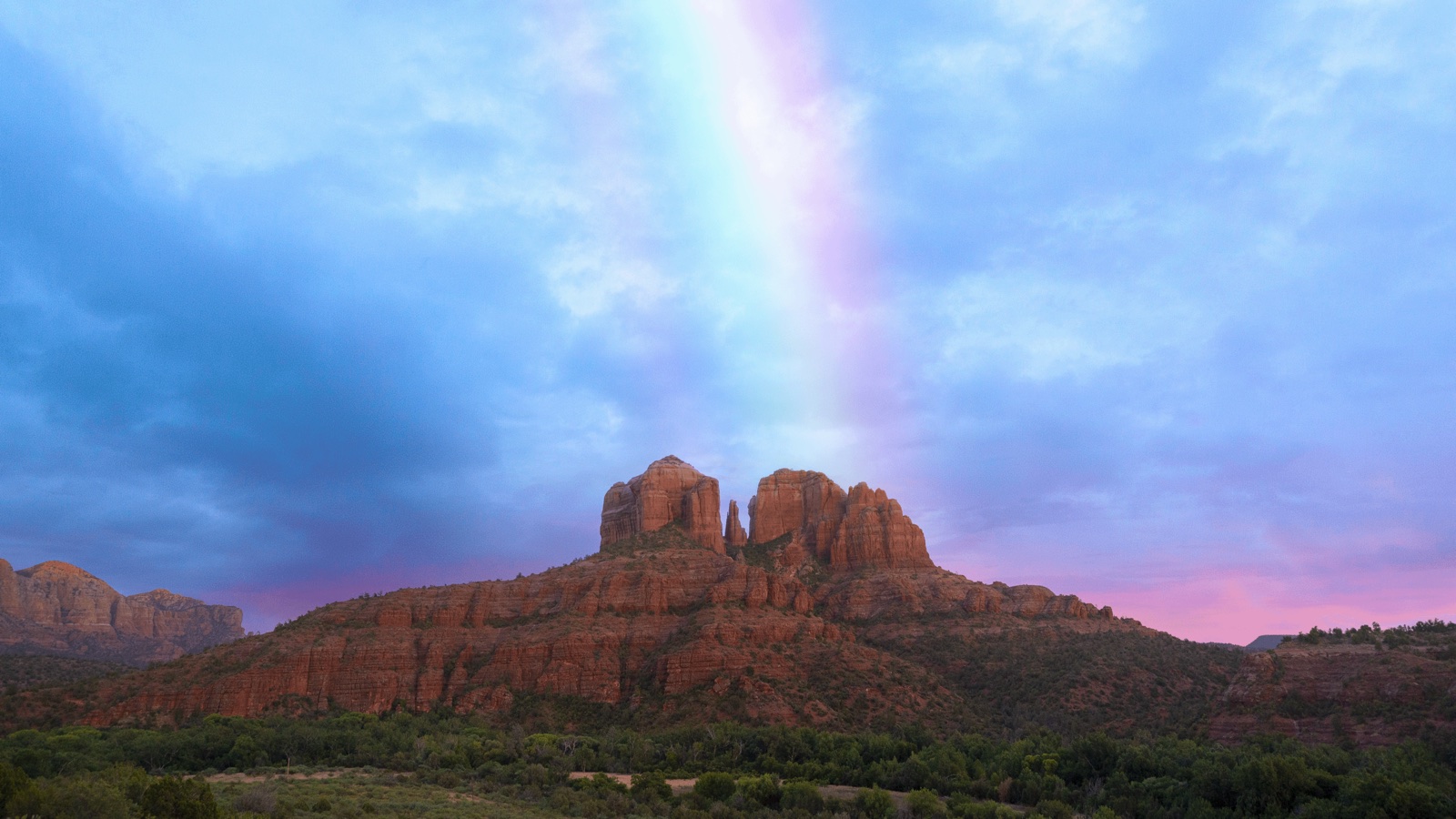 Cathedral Rock beneath a rainbow in Sedona, Arizona.