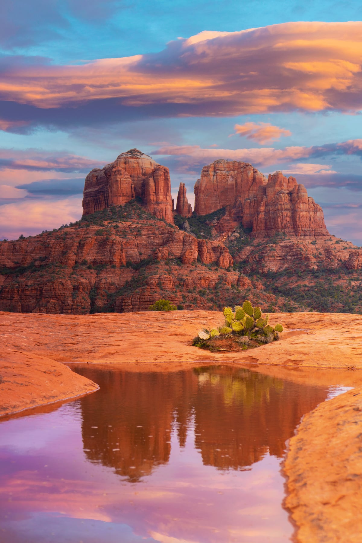 Cathedral Rock reflected in a seasonal pool beneath pink and blue clouds