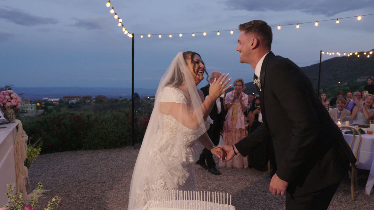 Abigail and Ethan laughing together during their wedding reception at The Little Daisy in Jerome