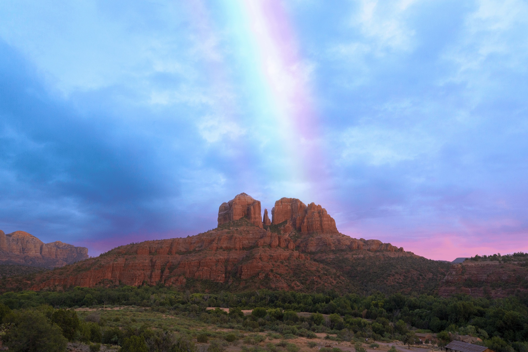 A rainbow rising above Cathedral Rock after a Sedona storm
