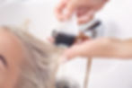 Hairdresser putting mask on woman's hair