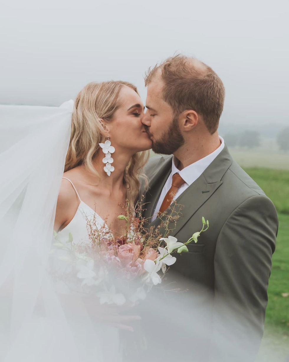 Thumbnail: Elegant bridal flower earrings close up