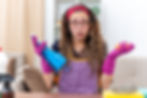 Young lady with cleaning supplies looking puzzled.