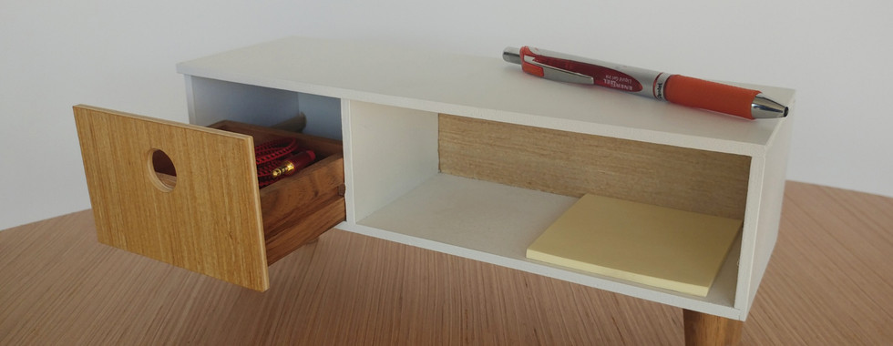 Mini console with drawer opened with a pen, post-it notes, and small cord for scale