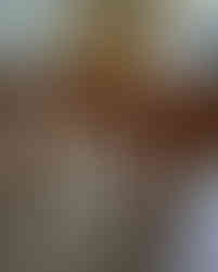 Photo of table in dining room with light reflecting off the top surface