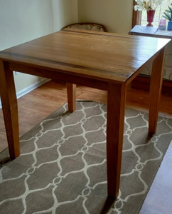 Photo of table in dining room with light reflecting off the top surface