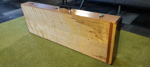 Photo of bass case standing on floor showing a beautiful figure in the birch plywood