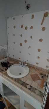 Bathroom vanity with no mirror on the wall behind it