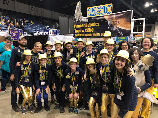 AoE Team posing with middle school robotics team.