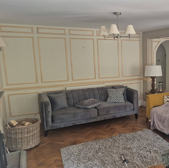 Custom wall joinery in a living room with sofas.