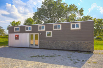 Stylish modular tiny home with two-tone siding and multiple windows.