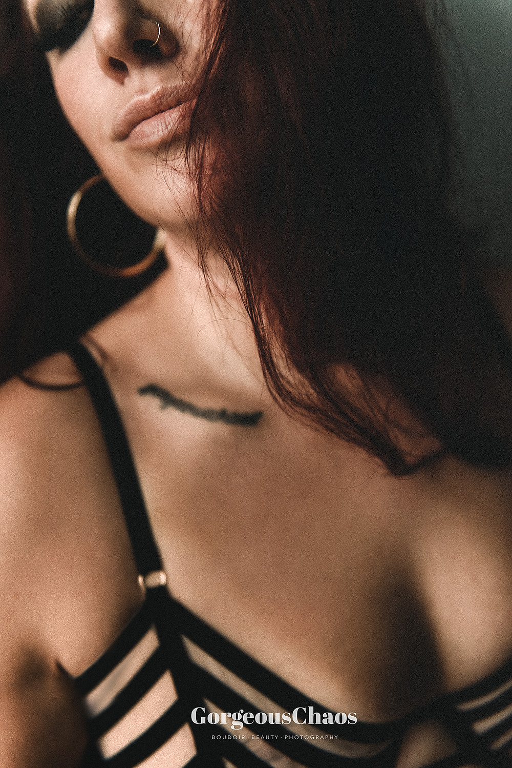 womens lips in focus with nose ring and closed eyes with lash extensions