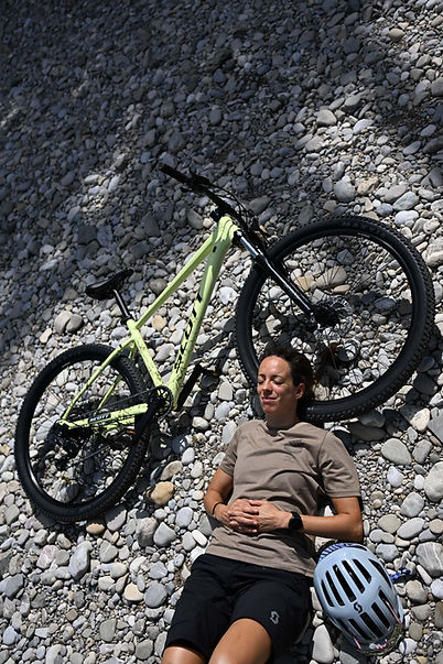 Bike rider resting on ground beside bike