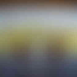 Table set for two in front of picture window overlooking vines, lake and mountains beyond. Domaine Thomson Central Otago NZ