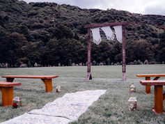 Wooden wedding arch at River Ridge against bush backdrop