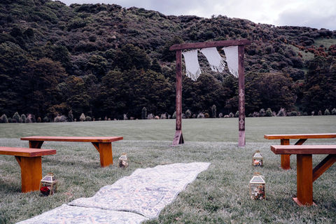Wooden wedding arch at River Ridge against bush backdrop