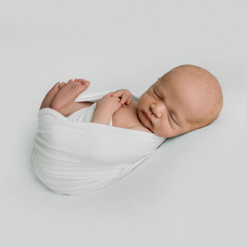 baby sleeping in a write wrap