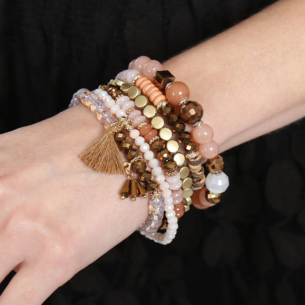 Miniatura: Woman's arm with stack of beaded bracelets, various colors and textures, fashion accessory.