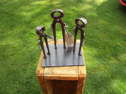 Group of small welded metal sculptures resembling abstract human figures, handcrafted from reclaimed materials in Kent by The Welding Carpenter