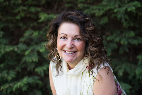 Head and shoulder photo of Heather Prince smiling, wearing a cream sleeveless blouse