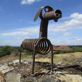 Handcrafted metal garden sculpture resembling a dog, made from reclaimed metal parts by The Welding Carpenter near Brecon