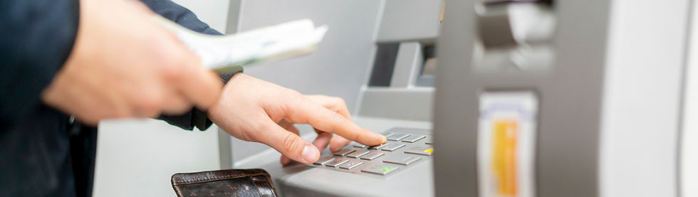 man withdrawing money, cash withdraw, using keyboard on an atm,