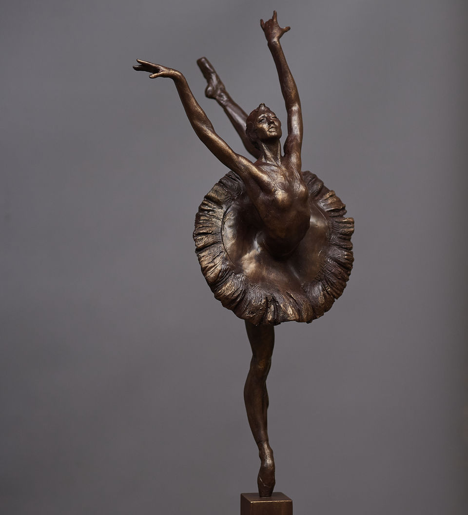 Figurative sculpture of a ballet dancer wearing a tutu