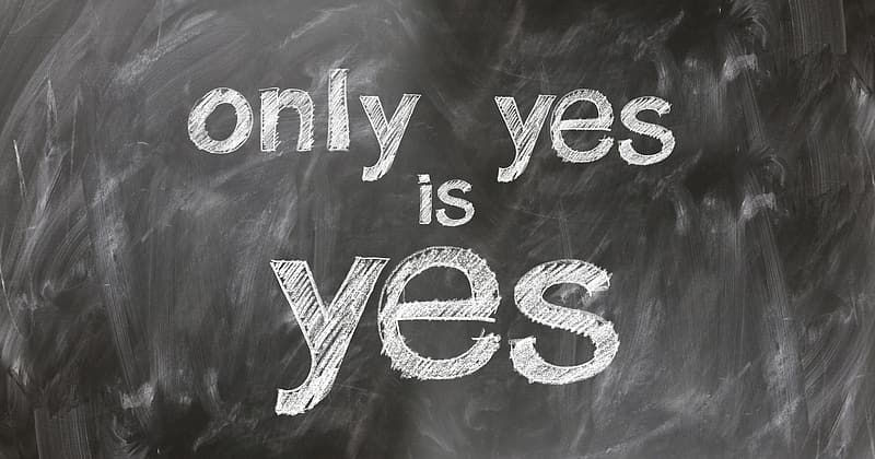 Chalk letters on a board that say ONLY YES IS YES