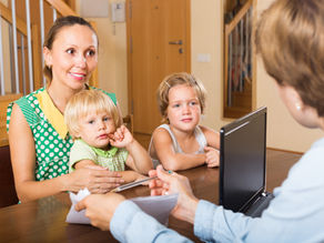 Mother with two young children speaking to a preschool administrator during a tour, representing important Questions to Ask Pre-K Providers in Pembroke Pines