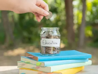 Summer Camp in Pembroke Pines Cost – saving coins in a jar labeled education