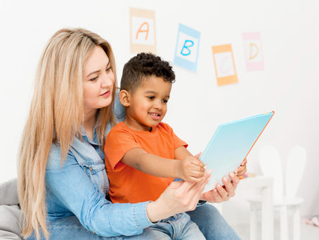 Mother helping her toddler read a book, representing how parents Choose the Right ELC Childcare Program for early learning and development.