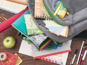 Backpack and school supplies representing items to pack for preschool in Pembroke Pines, Florida