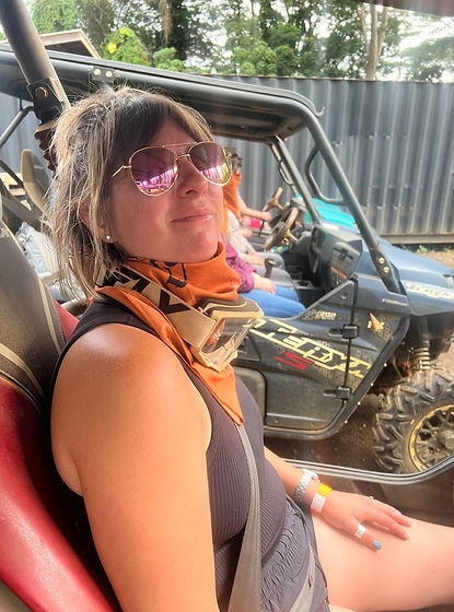 Alexis is sitting an ATV smiling at the camera wearing aviators and clearly feeling very cool.