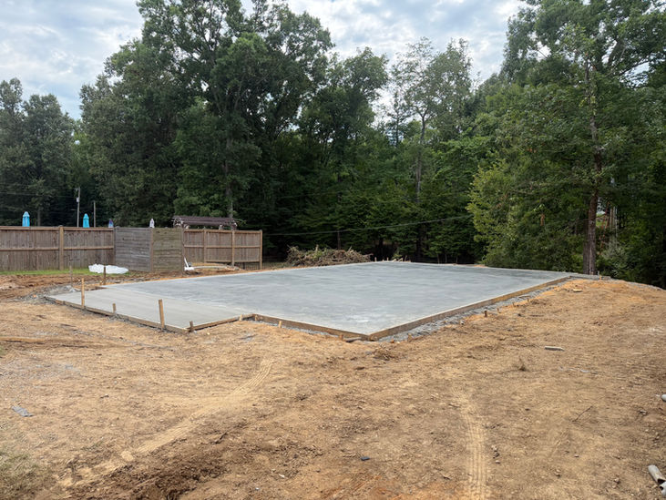 1. Monolithic concrete slab prepared for construction of a new metal building