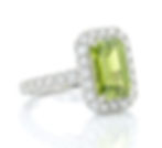 Ring with rectangular lime green gemstone surrounded by diamonds