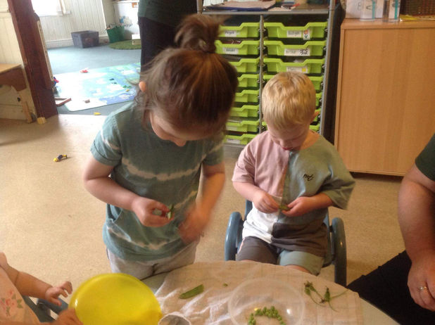 2 children at a table playing