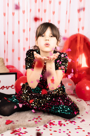young girl blowing kissing 