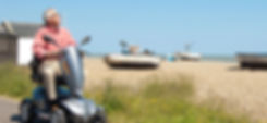 Man on mobility scooter at the beach