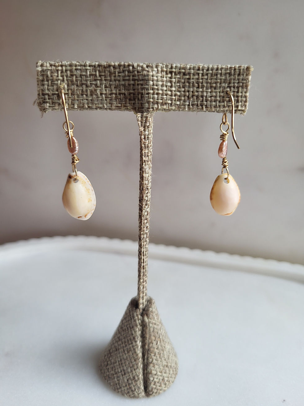 Thumbnail: Gold cowrie shell and pink pearl earrings