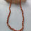 Thumbnail: Beaded sunstone necklace with hand knotted coral silk cord