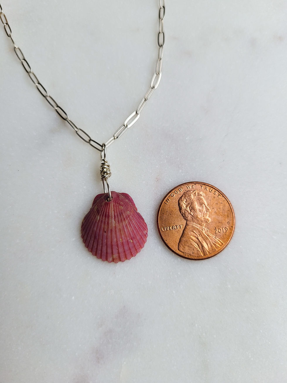Thumbnail: A maroon scallop shell wrapped with silver wire on a silver paperclip chain necklace